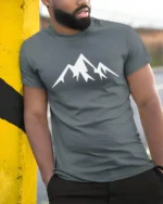 Minimalist Mountain Peak Nature Adventure Graphic T Shirt - model wearing grey tee, leaning on column