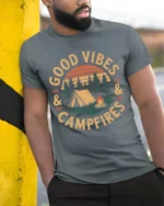 Good Vibes And Campfires Vintage Camping Graphic T Shirt - model wearing grey tee, leaning on column