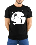 Boy Flying Kite Moonlight Silhouette Graphic T Shirt Dreamy Tee - model wearing black tee with hands behind back