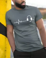 Music Heartbeat Headphones Graphic T Shirt Minimalist Audio Tee - model wearing grey tee, leaning on column