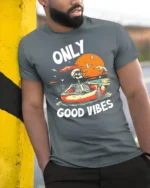 Only Good Vibes Skeleton Pool Float Sunset Graphic T Shirt - model wearing grey tee, leaning on column