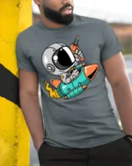 Galactic Astro Rider Rocket Ship Ray Gun Graphic Tshirt - model wearing grey tee, leaning on column