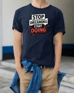 Motivational Stop Dreaming Start Doing Graphic Tshirt - model wearing navy tee with hands in pockets