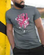 Retro Musical Cube Beats Pink Cassette Tape Graphic Tshirt - model wearing grey tee, leaning on column