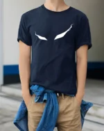Haunting Ghostly Eyes Wispy Trail Mystery Graphic Tee - model wearing navy tee with hands in pockets