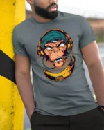 Groovy DJ Monkey Banana Headphones Retro Graphic Tshirt - model wearing grey tee, leaning on column