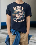 Lazy Cool Cat Busy Doing Nothing Retro Sunset Tshirt - model wearing navy tee with hands in pockets