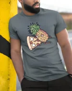 Amusing Pineapple Pizza Slice Cartoon Food Humor Tshirt - model wearing grey tee, leaning on column