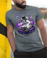 Astronaut DJ Cosmic Beats Electronic Music Graphic Tee - model wearing grey tee, leaning on column