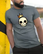 Regal Golden Crown Skull King Royal Urban Graphic Tshirt - model wearing grey tee, leaning on column