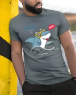Groovy Shark Sunglasses Cool Dude Beach Vibe Graphic Tshirt - model wearing grey tee, leaning on column