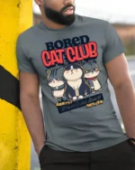 Gloomy Bored Cat Club Unimpressed Feline Graphic Tshirt - model wearing grey tee, leaning on column
