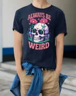 Whimsical Always Be Weird Floral Skull Graphic Tshirt - model wearing navy tee with hands in pockets