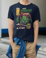 Retro Comic Book Cathulhu Monster Cat Graphic Tshirt - model wearing navy tee with hands in pockets