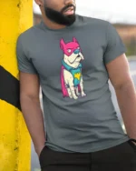 Funny Frenchie Superhero Pink Mask Graphic Comic Tshirt - model wearing grey tee, leaning on column
