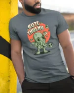 Adorable Cthulhu World Destroyer Mythical Graphic Tshirt - model wearing grey tee, leaning on column