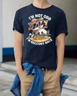 Chill Raccoon Sunglasses Summer Vacation Beach Graphic Tee - model wearing navy tee with hands in pockets