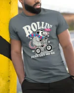 Funny Possum Riding Bicycle Rollin Free Graphic Tshirt - model wearing grey tee, leaning on column