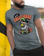 Aggressive Pigeon Baseball Bat Bets Callejeros Tshirt - model wearing grey tee, leaning on column
