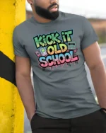 Vibrant Retro Kick It Old School Graffiti Graphic Tshirt - model wearing grey tee, leaning on column