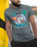 Cool Surfing Seal Catch The Wave Beach Graphic Tshirt - model wearing grey tee, leaning on column