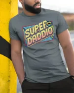 Retro Pixel Super Daddio Mustache Gamer Graphic Tshirt - model wearing grey tee, leaning on column