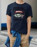 Fishing Reely Lures Me In Funny Angler Sport Graphic Tee - model wearing navy tee with hands in pockets