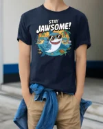 Cheerful Stay Jawsome Shark Beach Vacation Graphic Tshirt - model wearing navy tee with hands in pockets