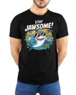 Cheerful Stay Jawsome Shark Beach Vacation Graphic Tshirt - model wearing black tee with hands behind back