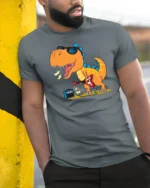 Rockstar Dinosaur Playing Electric Guitar Retro Music Tshirt - model wearing grey tee, leaning on column