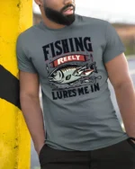Fishing Reely Lures Me In Funny Angler Sport Graphic Tee - model wearing grey tee, leaning on column
