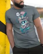 Surreal Wired Cyber Skull Biological Brain Graphic Tshirt - model wearing grey tee, leaning on column