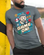 Vibrant Pixel Art Game On Retro Controller Graphic Tshirt - model wearing grey tee, leaning on column