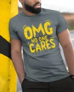 Sarcastic OMG No One Cares Dripping Text Graphic Tshirt - model wearing grey tee, leaning on column