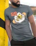 Fragile Mind Cracked Egg Skull Funny Sarcastic Graphic Tshirt - model wearing grey tee, leaning on column