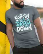 Inspirational Nobody Can Drag Me Down Motivational Tshirt - model wearing grey tee, leaning on column
