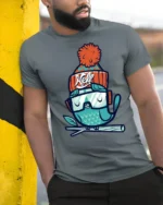 Chilly Winter Owl Beanie Hat Snow Goggles Graphic Tshirt - model wearing grey tee, leaning on column