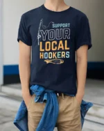 Sarcastic Support Your Local Hookers Fishing Graphic Tshirt - model wearing navy tee with hands in pockets