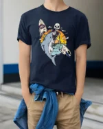 Skeleton Surfer Riding Shark Tropical Sunset Graphic Tee - model wearing navy tee with hands in pockets