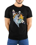 Skeleton Surfer Riding Shark Tropical Sunset Graphic Tee - model wearing black tee with hands behind back