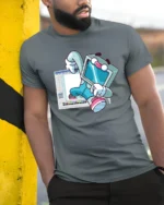 Retro Computer Character Breaking From Software Graphic Tshirt - model wearing grey tee, leaning on column