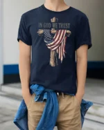 Patriotic Christian Wooden Cross American Flag Graphic Tee - model wearing navy tee with hands in pockets