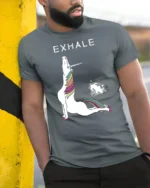 Sarcastic Exhale Unicorn Farting Rainbow Yoga Graphic Tee - model wearing grey tee, leaning on column