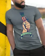 Sarcastic Go Vegan Fist Holding Cartoon Carrot Graphic Tee - model wearing grey tee, leaning on column