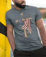 Patriotic Christian Wooden Cross American Flag Graphic Tee - model wearing grey tee, leaning on column
