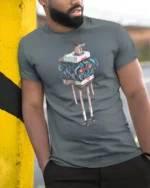 Funny Living Luggage Chest Cute Face Long Legs Graphic Tee - model wearing grey tee, leaning on column
