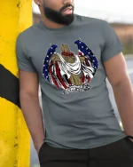 Patriotic Angel Wings Wooden Cross USA Flag Graphic Tee - model wearing grey tee, leaning on column