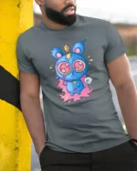 Adorable Electric Monster Crown Pink Splat Graphic Tshirt - model wearing grey tee, leaning on column