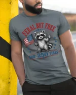Feral But Free Raccoon American Flag Patriotic Tshirt - model wearing grey tee, leaning on column