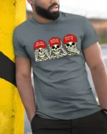 Politically Satirical Skeleton Wise Monkey Mocking Graphic Tee - model wearing grey tee, leaning on column